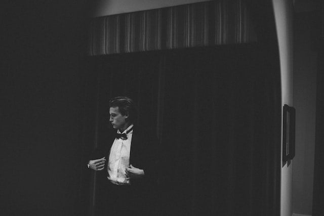 a man wearing a black tuxedo