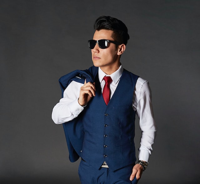 a men wearing suit and carrying a vest