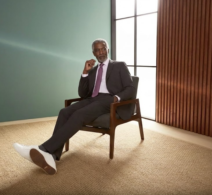 male wearing black suit on chair - new arrival banner