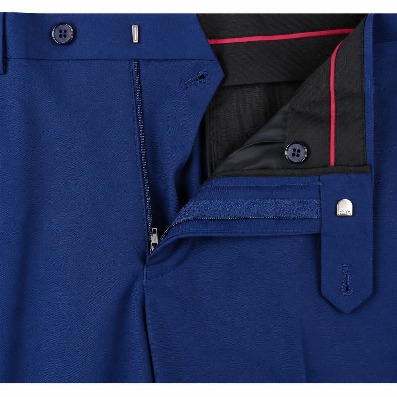Close-up of a pair of blue trousers showing the front zip fly, button closure, flap pocket, and black inner lining with pink contrast stitching.