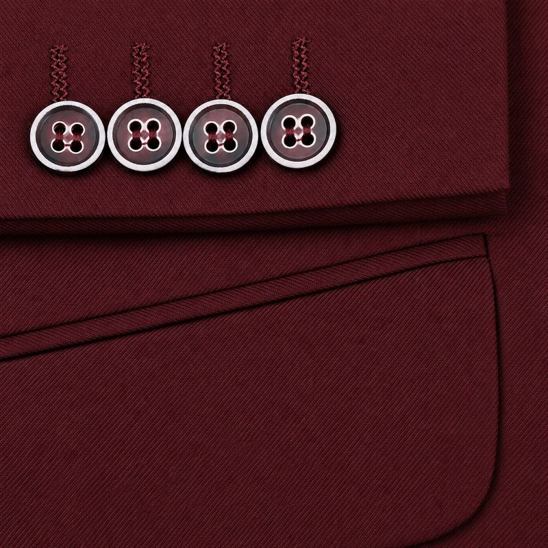 Close-up of a burgundy fabric garment detail showing four decorative buttons on the cuff with braided tab accents and a pocket below.