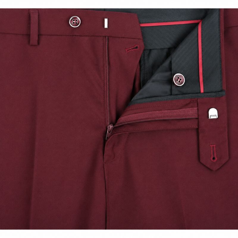 Close-up of burgundy trousers showing the waistband, front zip closure, and a matching zippered pocket with a buttoned flap.