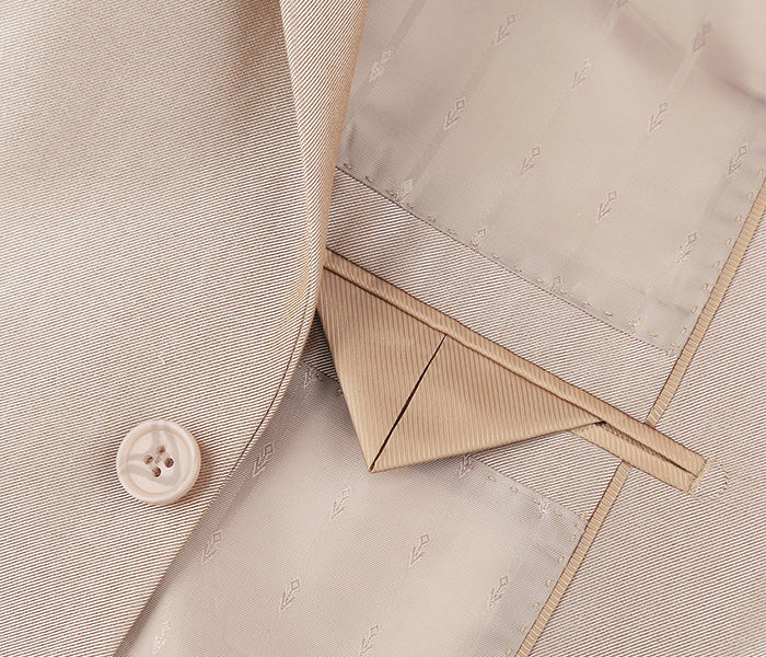 Close-up of a Renoir refined beige silk tie, exquisitely complementing the Italian sharkskin suit.