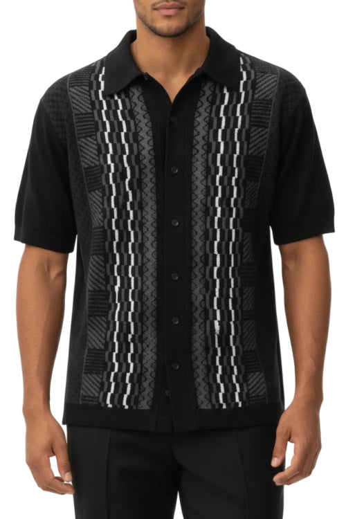 Black patterned shirt worn by a person on a white background