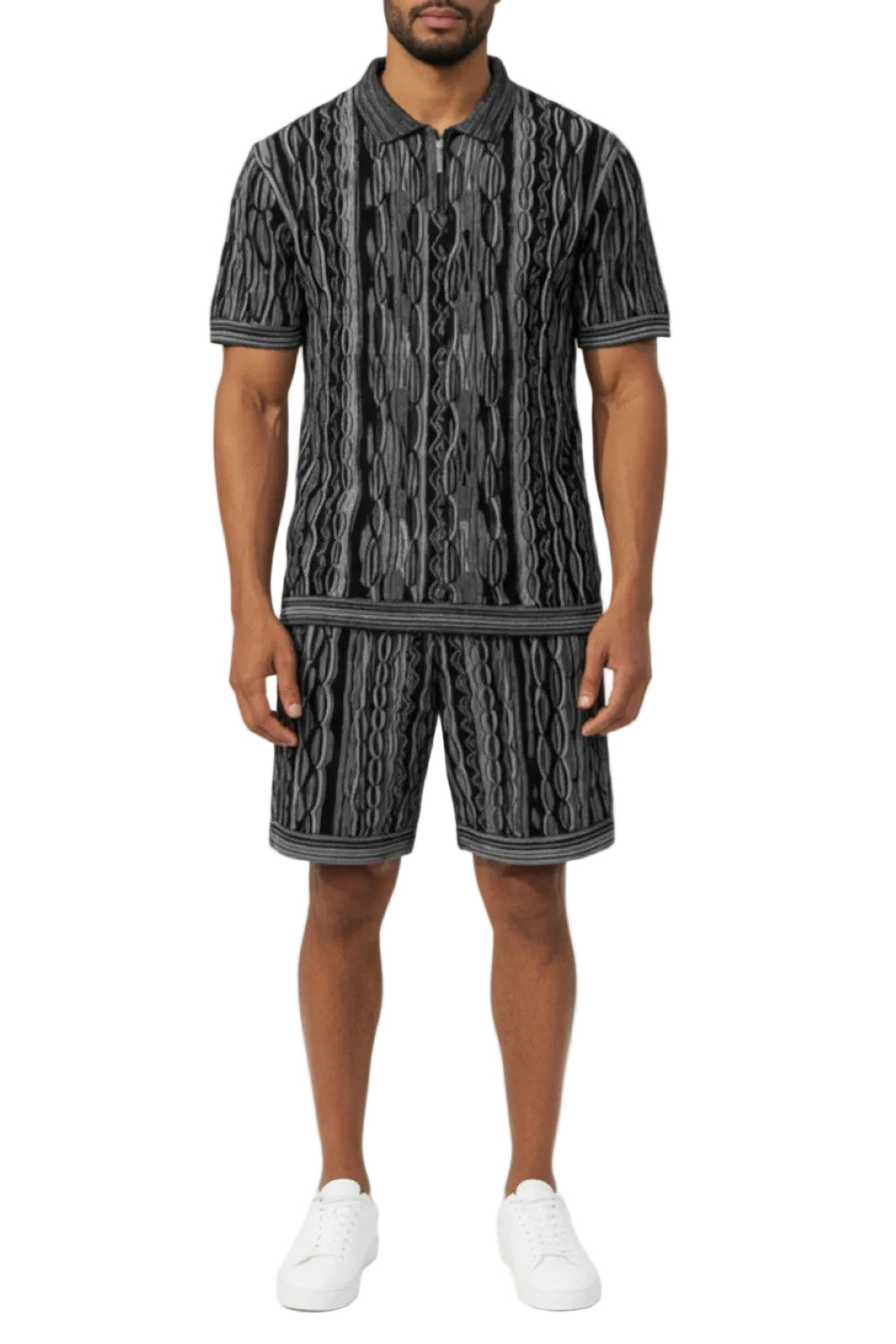 Man wearing a black and gray patterned outfit on a white background