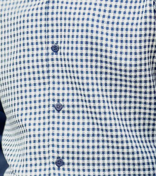 Detail of Montique's premium navy mini-checkered fabric, showcasing its sophisticated weave for a men's walking suit.