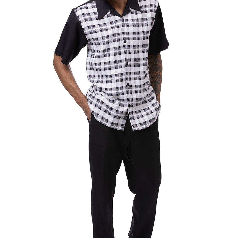 Person wearing a black and white checkered shirt over a black base with black pants on a white background