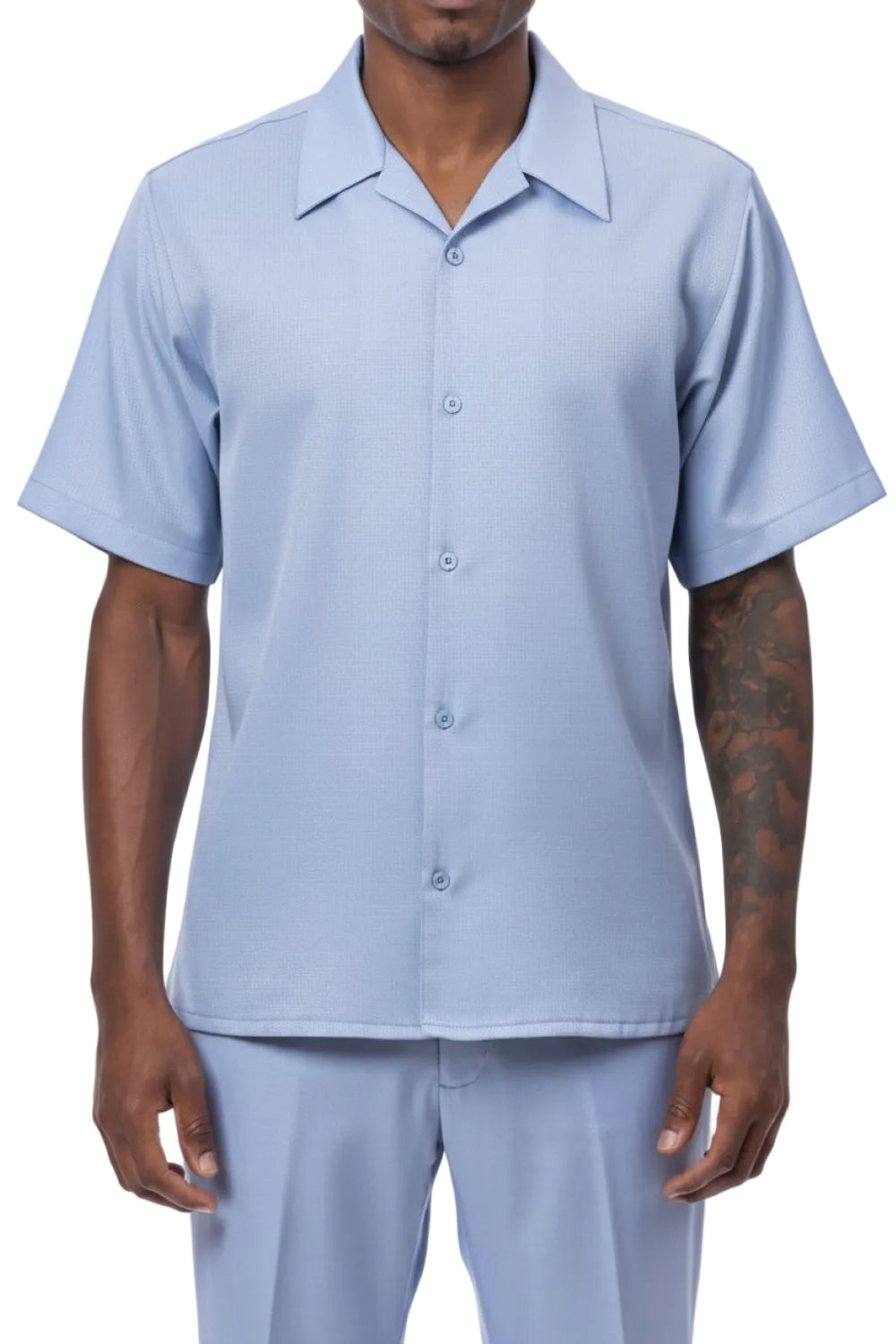 Man wearing a light blue button-up shirt and pants on a white background