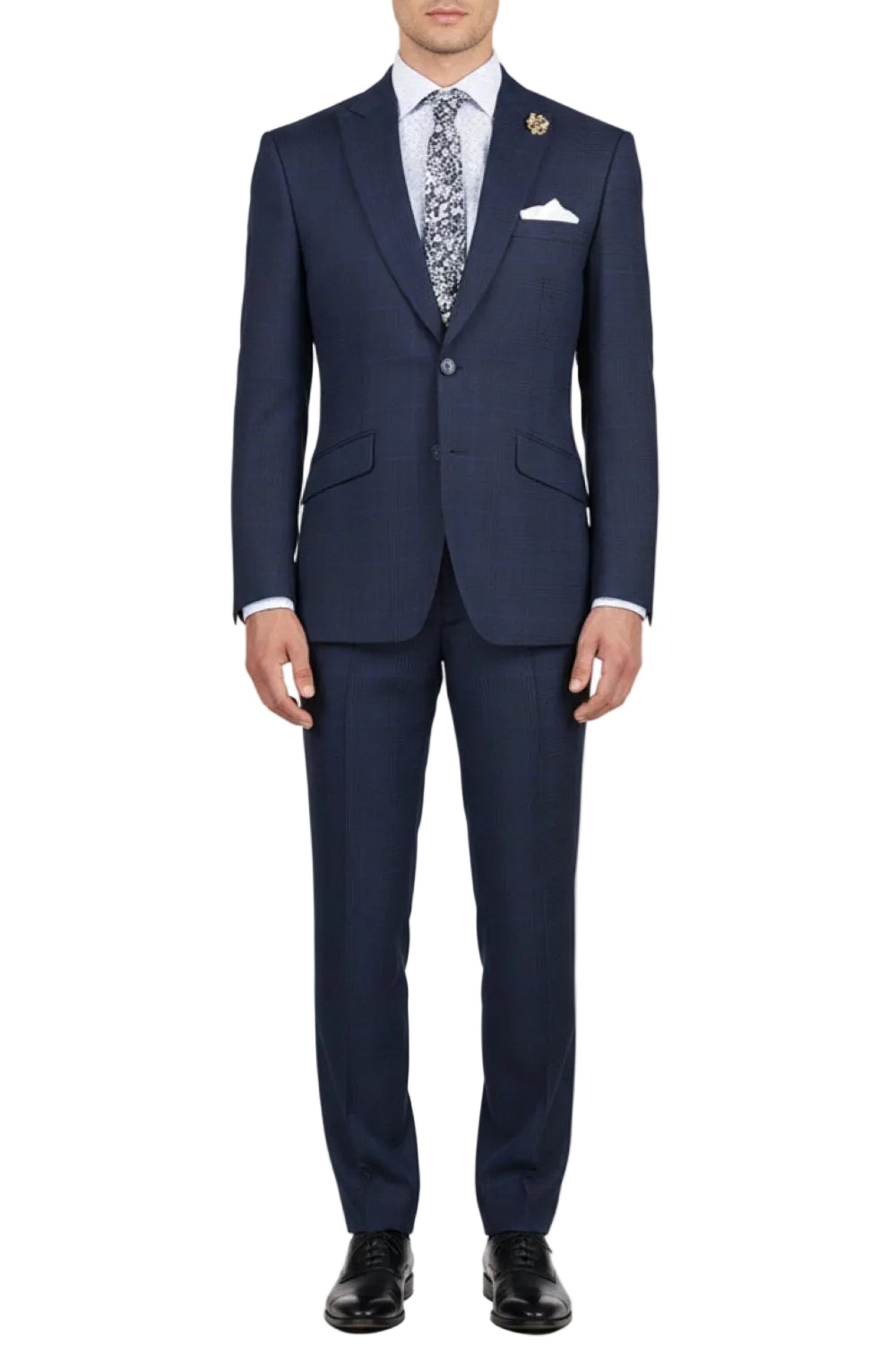 Navy suit with patterned tie and pocket square on a white background