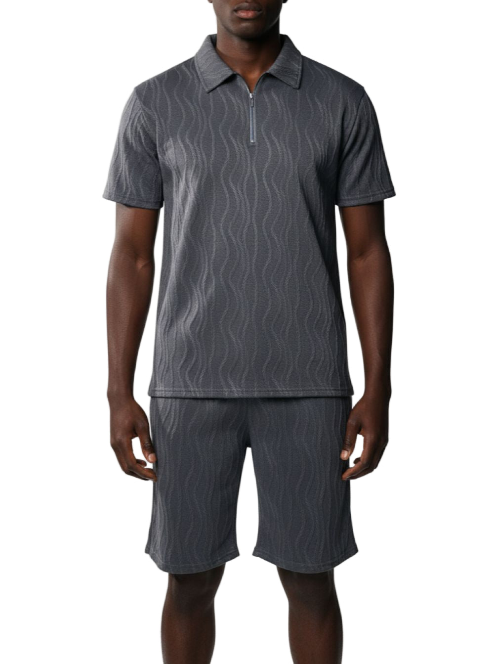 Man wearing a gray patterned polo shirt and shorts on a white background
