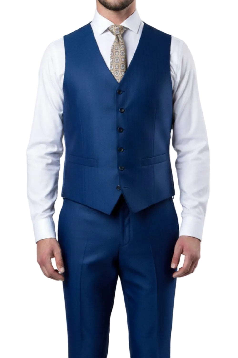 Man wearing a blue suit vest and pants with a white shirt and patterned tie on a light gray background