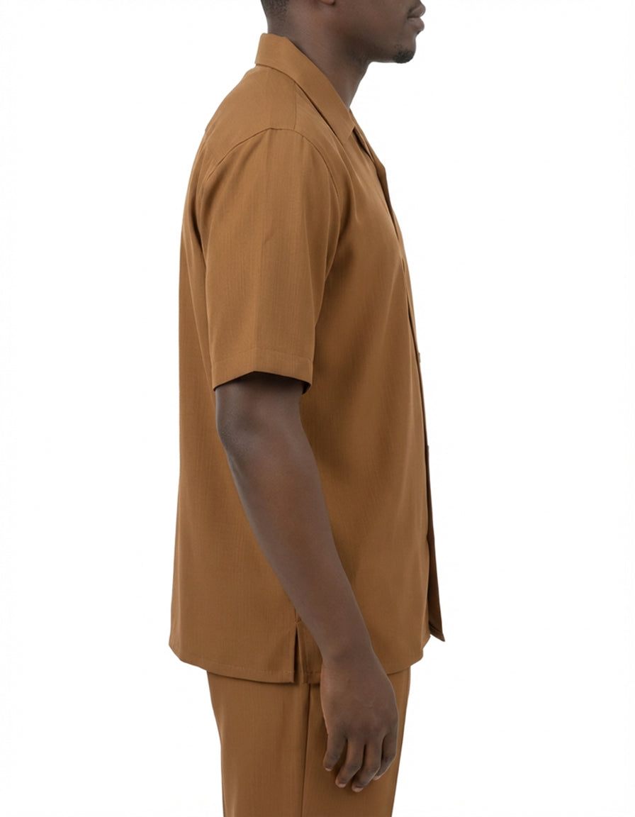 Close-up of a solid button on the Taupe Short Sleeve Summer Walking Suit Set with Flexible Waist Pants.