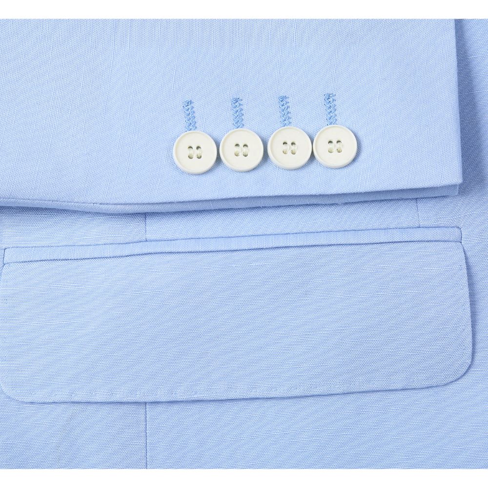 Close-up of Renoir's refined light blue linen slim fit suit lapel, showcasing impeccable tailoring and premium texture.