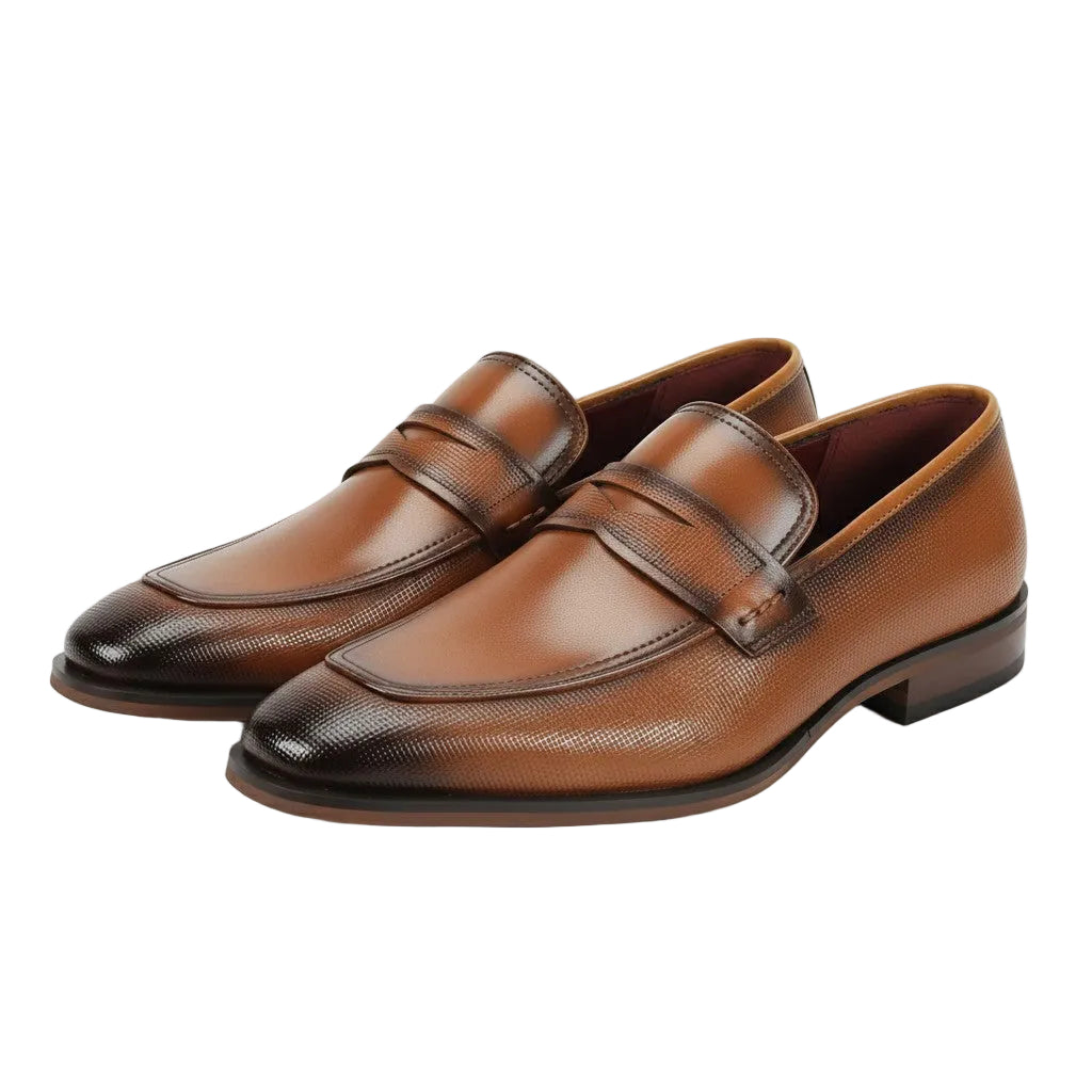 Pair of Tan leather loafers on a white background