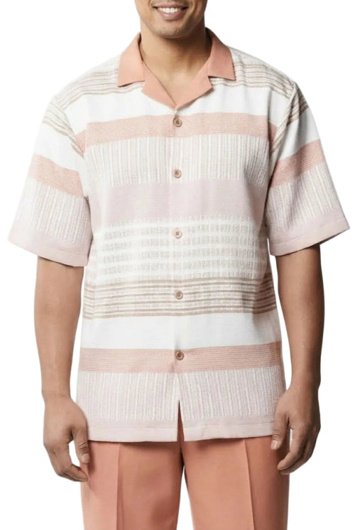 A man wearing a short-sleeve button-up camp shirt with horizontal stripes in white, light pink, and beige, paired with peach pants against a white background.