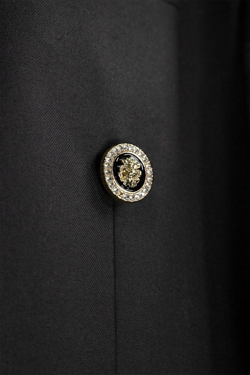 Close-up of a decorative button on a black fabric background
