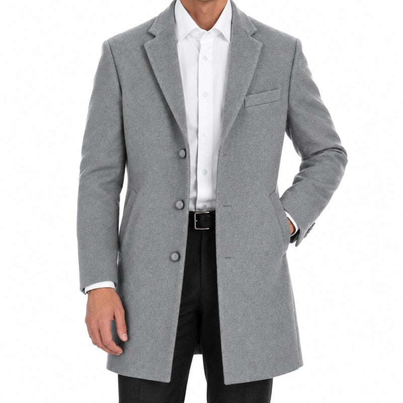 A man wearing a light gray wool-blend overcoat over a white dress shirt and black trousers, shown from the neck down against a plain white background.