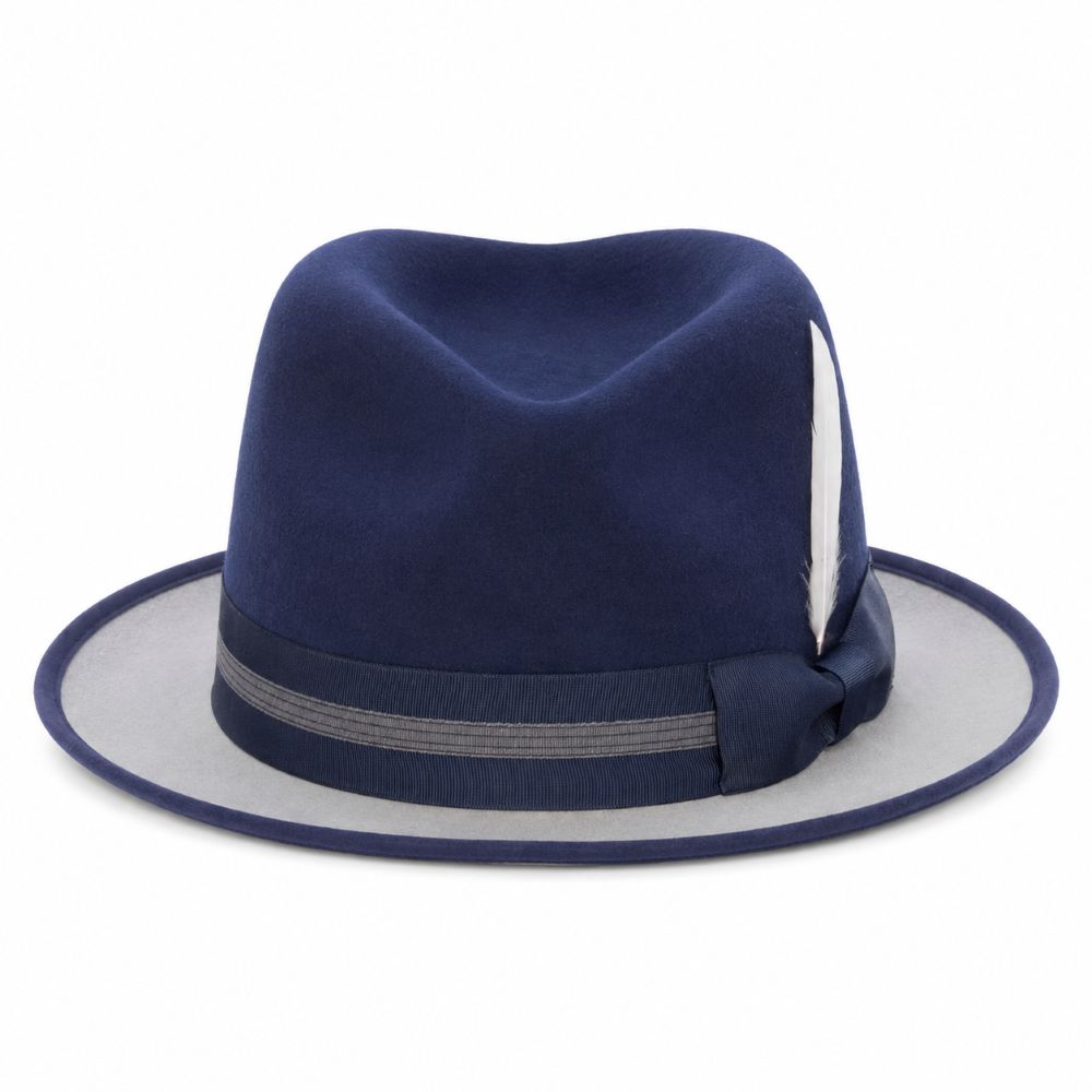 A navy blue felt fedora hat with a matching navy blue band and a light gray underside of the brim, featuring a white feather accent on the side.