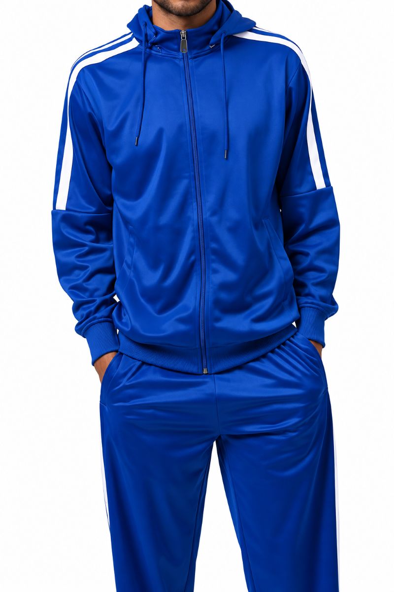 A man wearing a royal blue tracksuit with white stripes on the shoulders and sleeves, featuring a full-zip hoodie and matching pants, set against a plain white background.