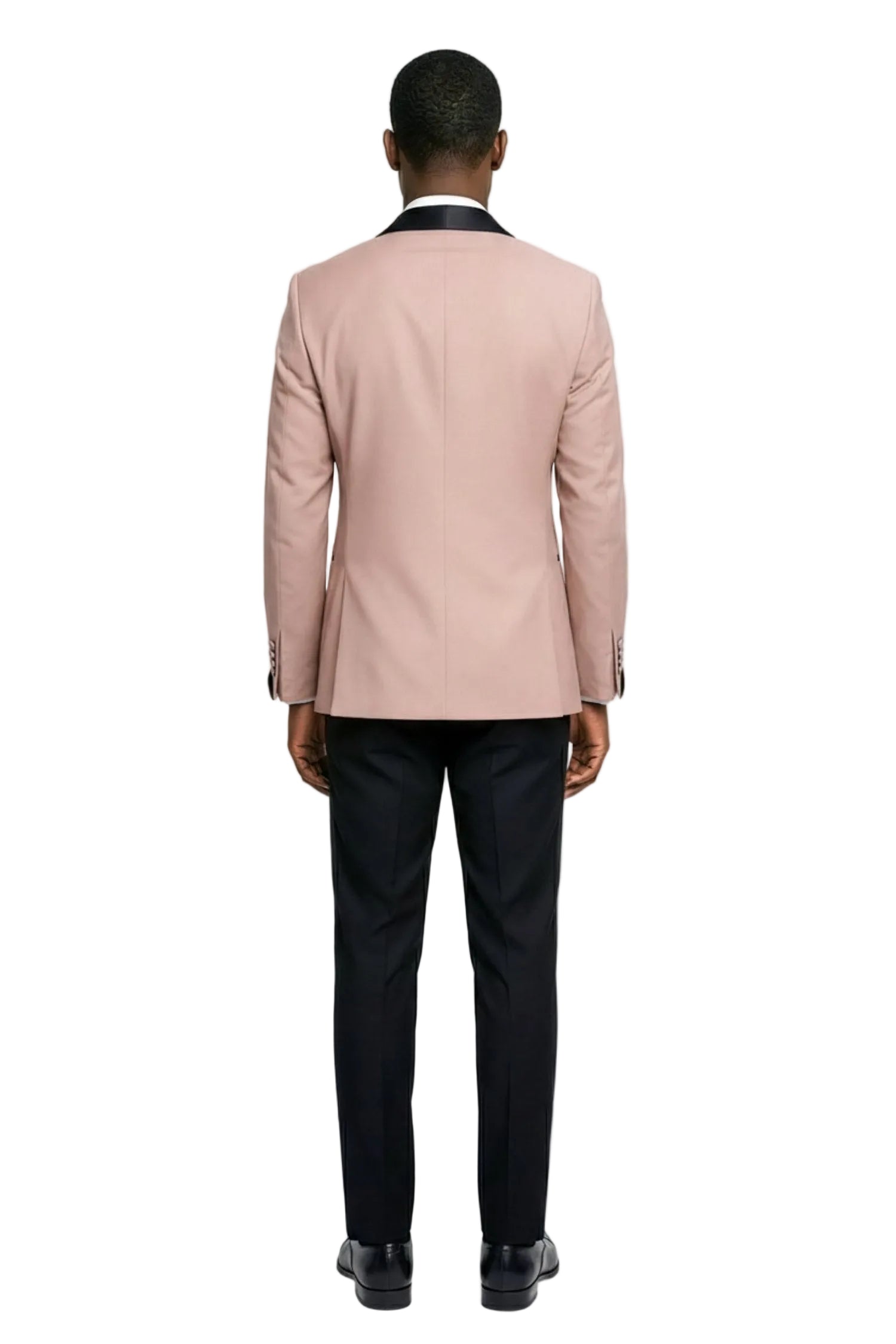 Person wearing a light pink blazer and black pants on a white background