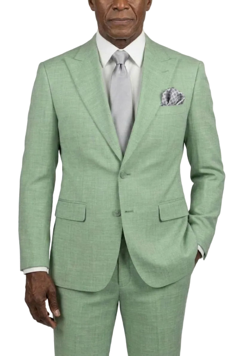 A man wearing a light green suit styled with a white dress shirt and a light gray tie and handkerchief against a plain white background.
