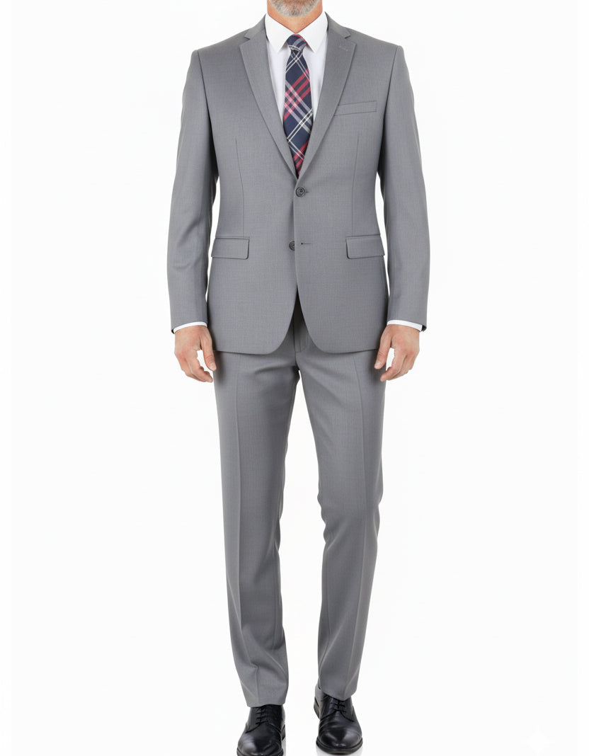 Man wearing a gray suit with a plaid tie on a white background