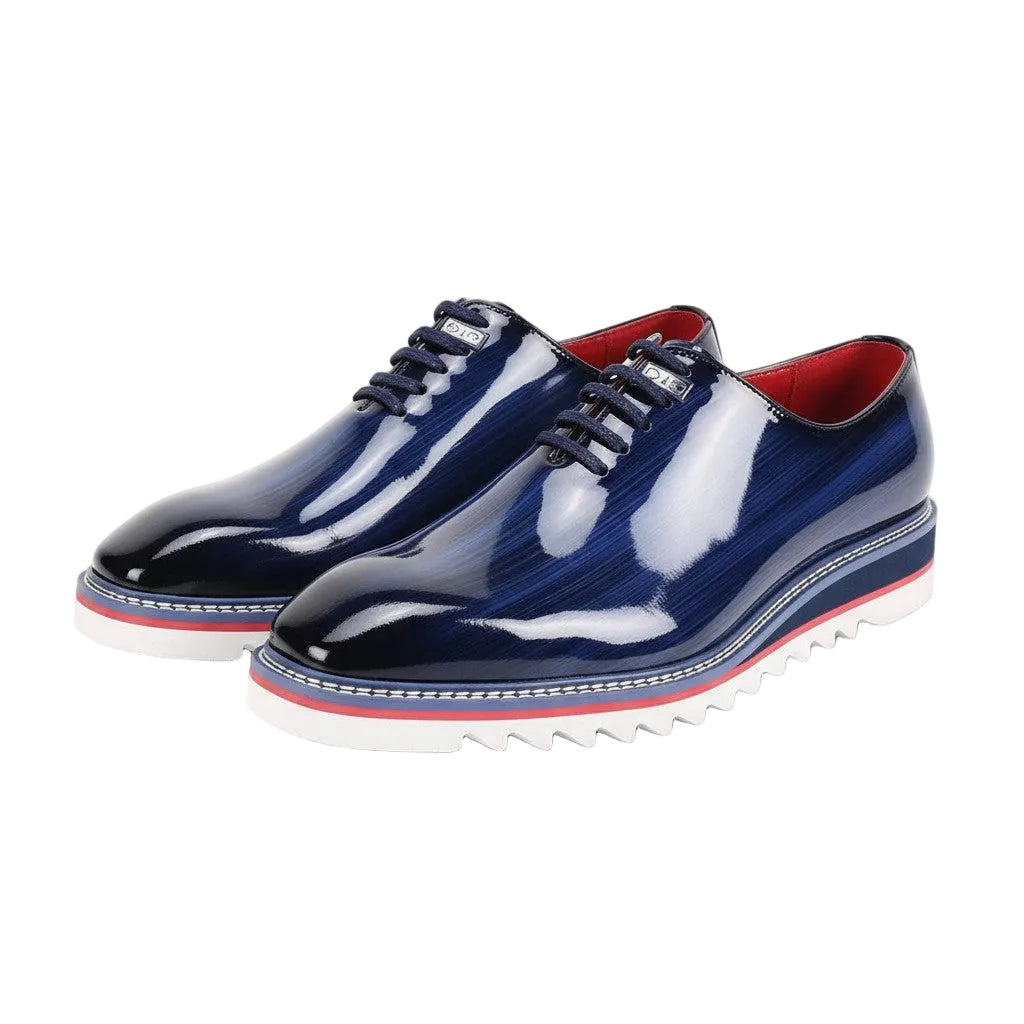 Pair of cobalt blue and white shoes with red accents on a white background