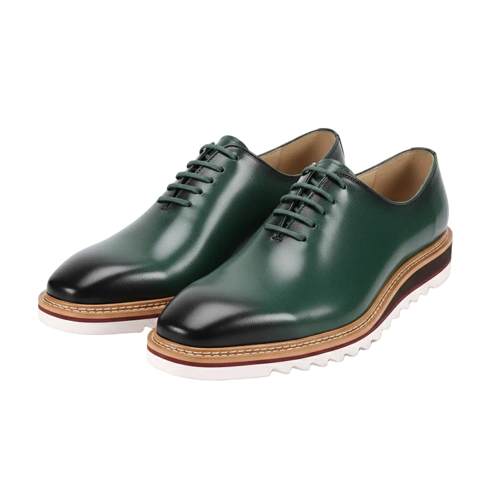 Green leather shoes with black toes on a white background