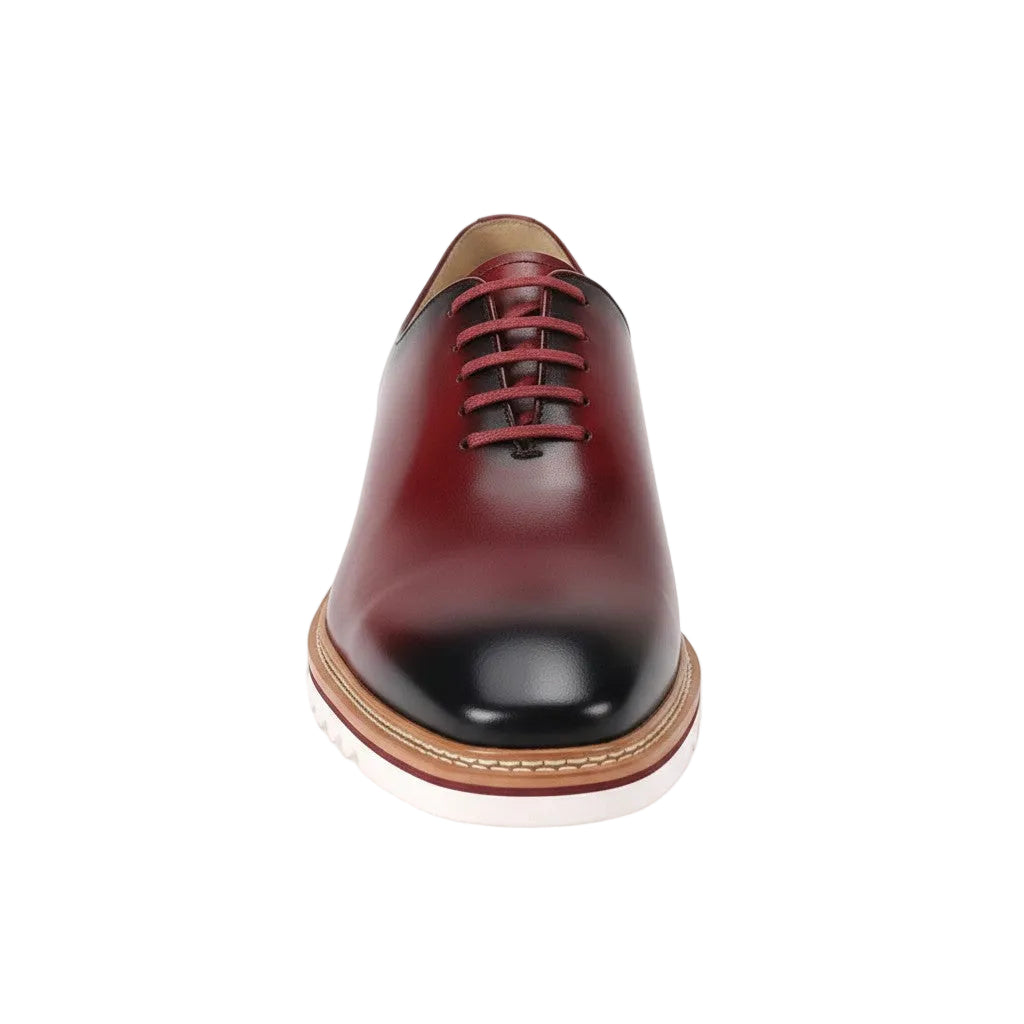 Wine leather shoe with a brown sole on a white background
