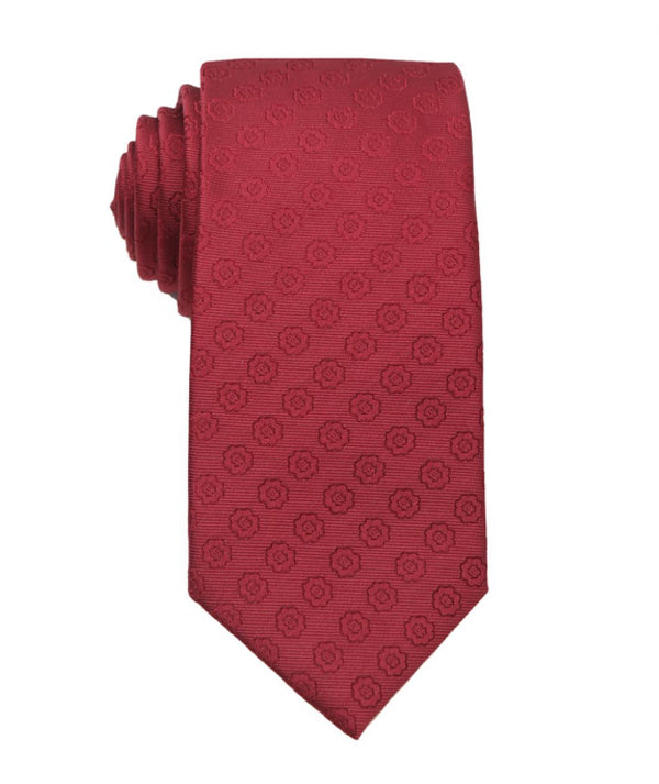 A folded red necktie with a repeating tonal circular geometric pattern, shown on a plain white background.