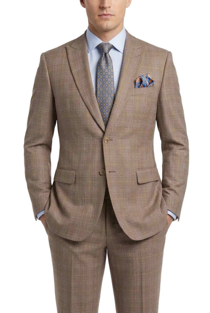 A man wearing a brown and beige plaid suit with a light blue dress shirt, patterned tie, and matching pocket square, photographed against a plain white studio background.