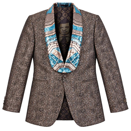 A men's single-breasted blazer in a brown and beige micro-patterned tweed, featuring a bold geometric patterned shawl collar in blue, beige, and brown, and a black patterned inner lining.