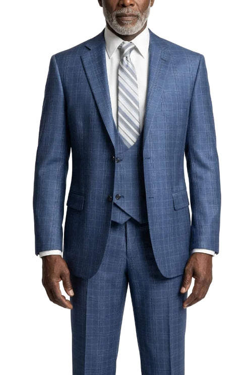 A man wearing a blue three-piece suit with a subtle windowpane plaid pattern, paired with a white dress shirt and a light blue and white striped tie, photographed against a light gray studio background.