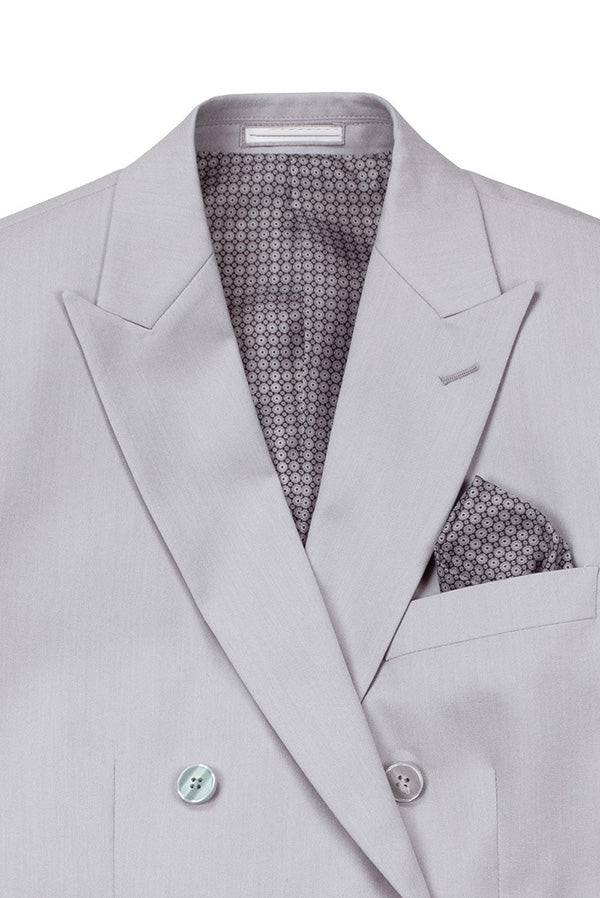 Detail shot of an elegant silver slim fit double-breasted men's suit jacket, highlighting premium quality fabric.