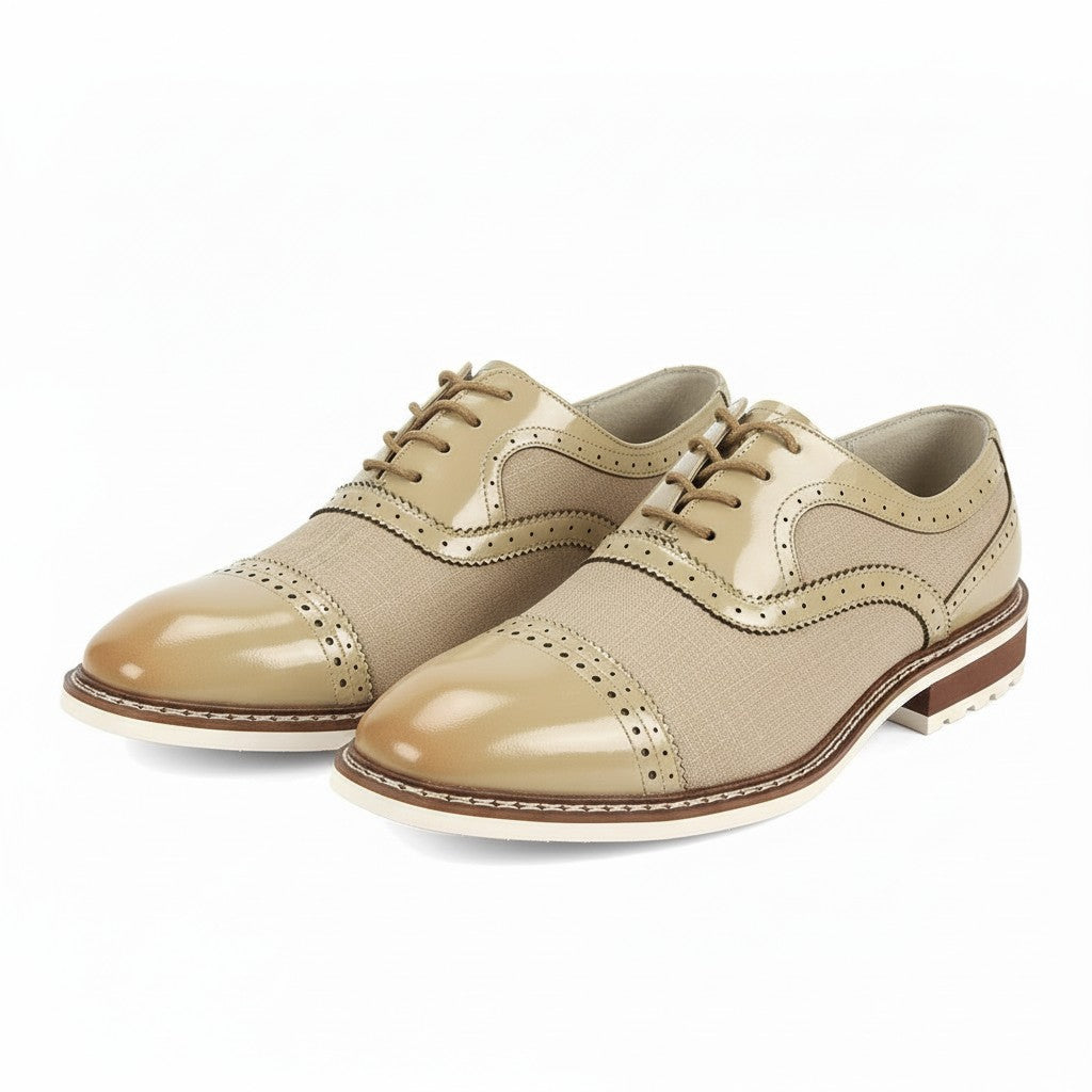 Pair of beige leather shoes with brown soles on a white background