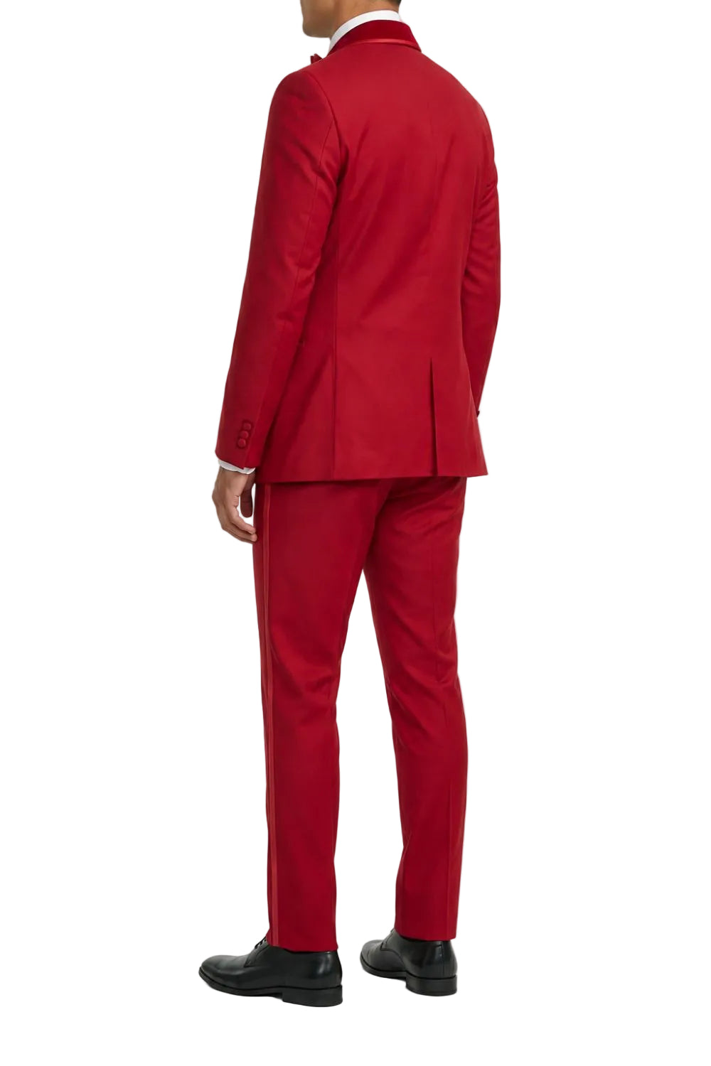 A man wearing a bright red two-piece suit, shown from the back, paired with a white collared shirt and black dress shoes, against a plain white background.