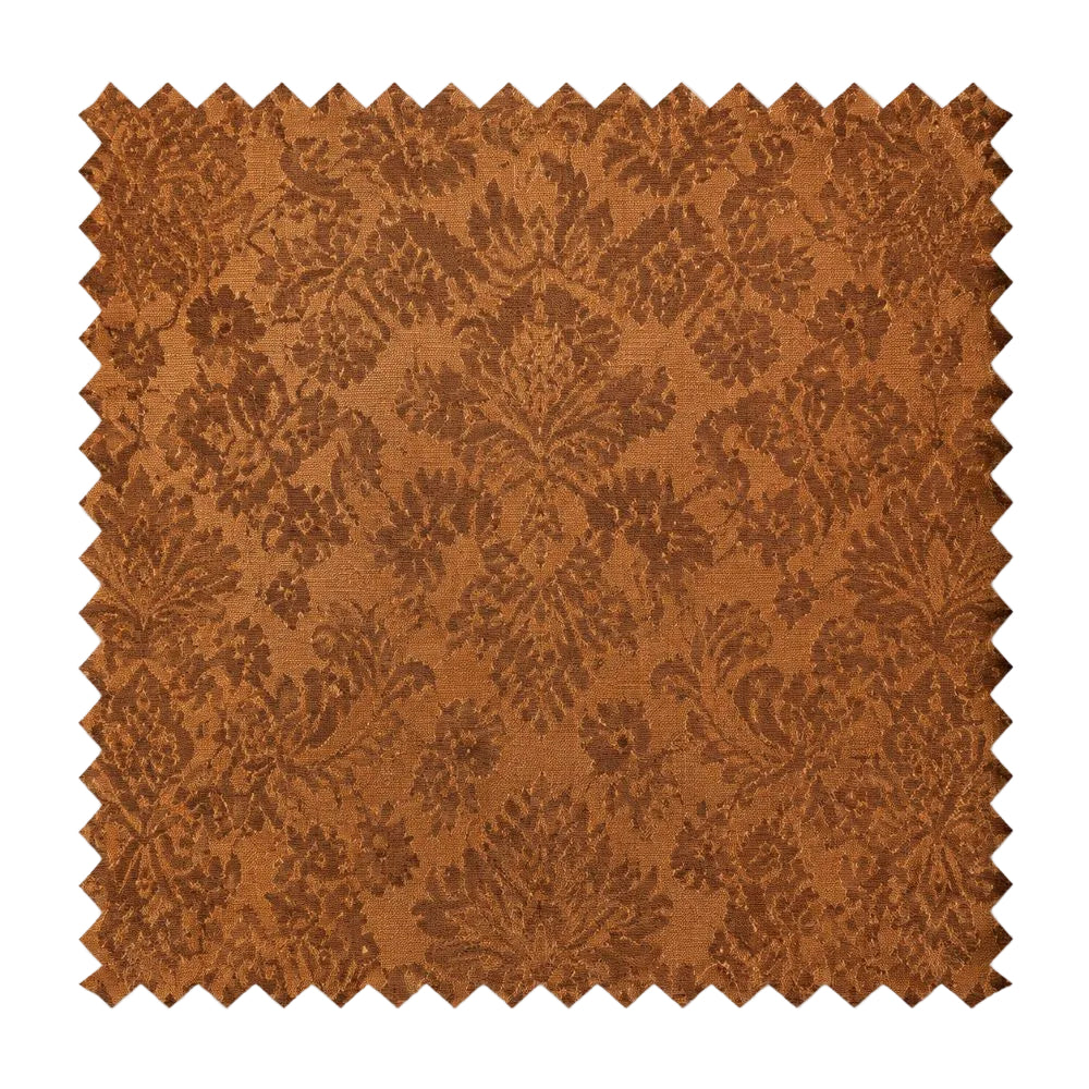 A square fabric swatch with serrated zigzag edges, featuring a warm rust-brown damask pattern on a lighter tan background, shown against a plain white background.