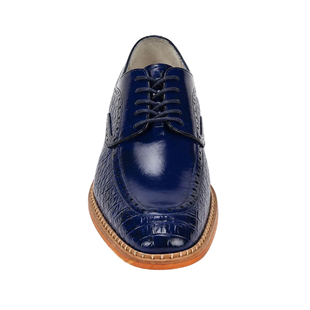 A single navy blue leather oxford-style shoe with a crocodile-embossed toe cap, matching laces, and a light brown stacked sole, shown from a front-facing perspective on a white background.