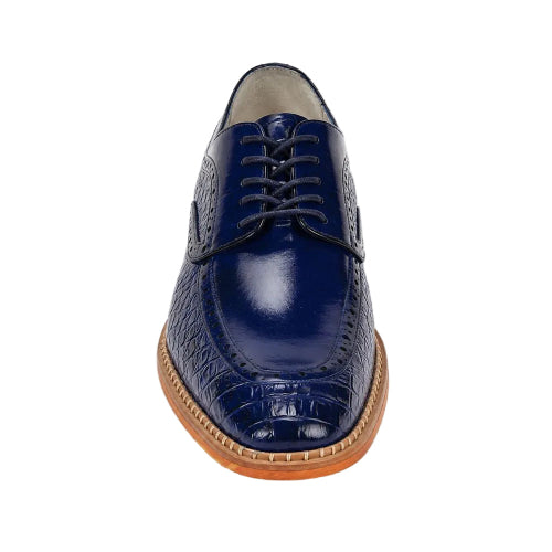 A single navy blue leather oxford-style shoe with a crocodile-embossed toe cap, matching laces, and a light brown stacked sole, shown from a front-facing perspective on a white background.