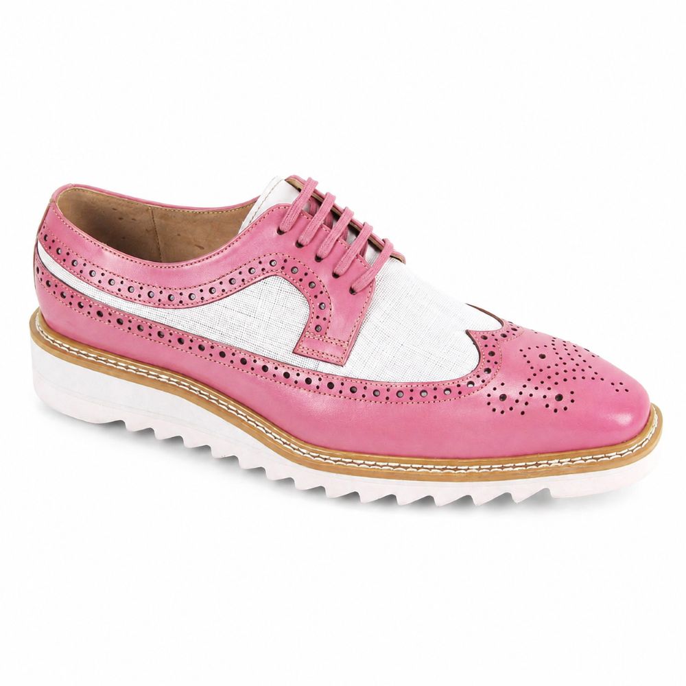 A pink and white leather wingtip brogue shoe with a chunky white sole featuring a zigzag edge and tan stitching, shown from a side profile on a white background.