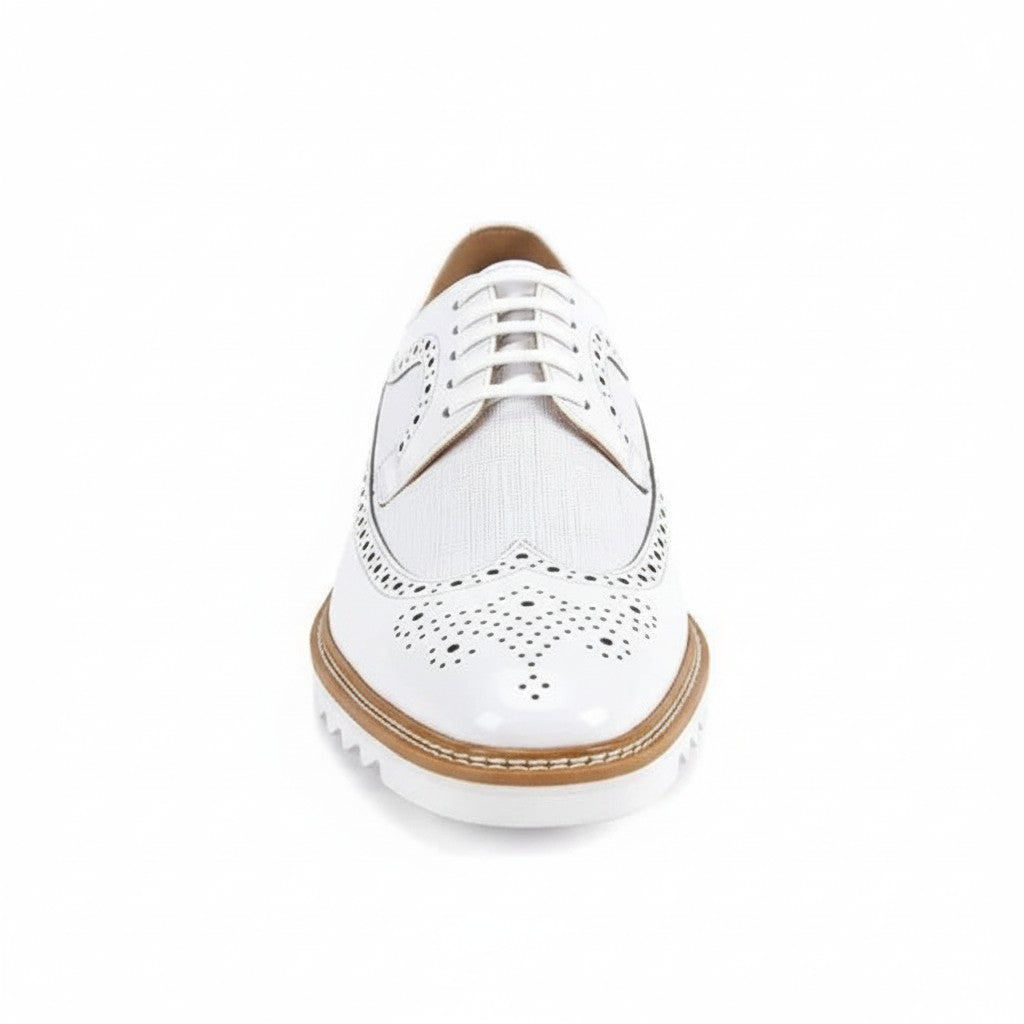 White brogue shoe with brown accents on a white background