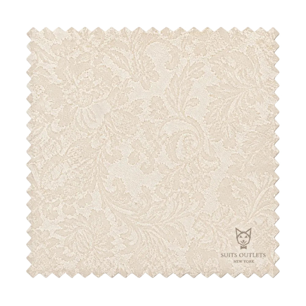 A square fabric swatch with scalloped edges, featuring a light beige and cream damask floral pattern. The Suits Outlets New York logo is printed in the bottom right corner.