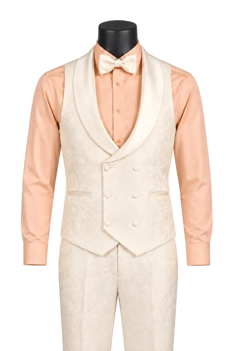 A formal tuxedo outfit displayed on a black mannequin torso against a light gray studio background. The set includes a peach long-sleeve dress shirt, a peach bow tie, and a cream satin peak lapel tuxedo vest with matching cream trousers.