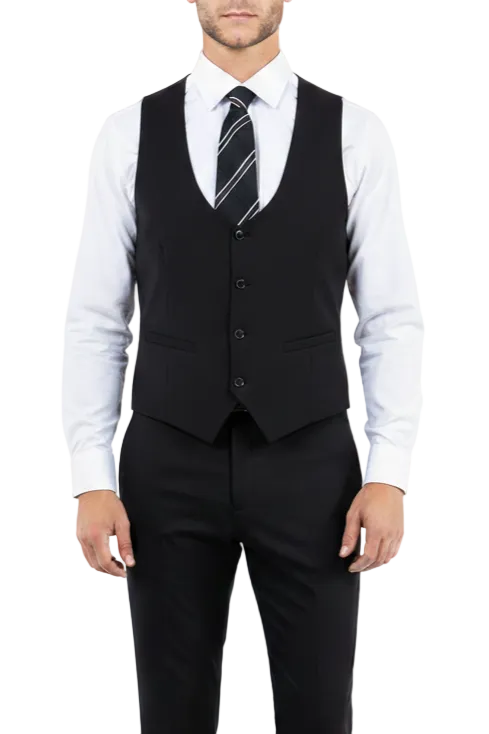 Man wearing a black vest over a white shirt with a striped tie on a white background