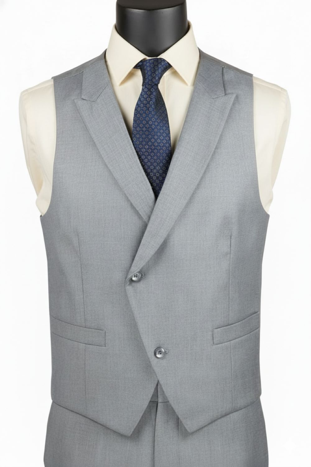 Gray suit vest with a white shirt and blue tie on a mannequin.