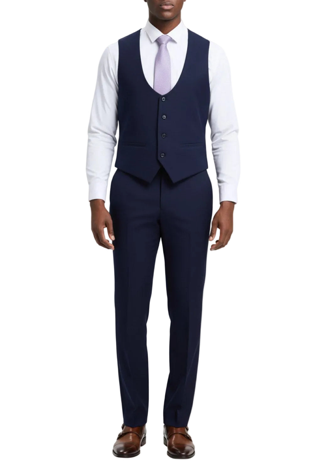 Man wearing a navy suit with a white shirt and brown shoes on a white background
