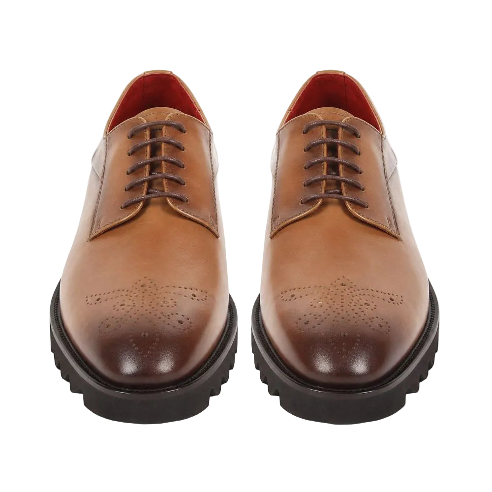 A pair of men's brown leather oxford shoes with brogue detailing on the toe, dark brown laces, and thick black lug soles, shown from a front-facing perspective on a white background.