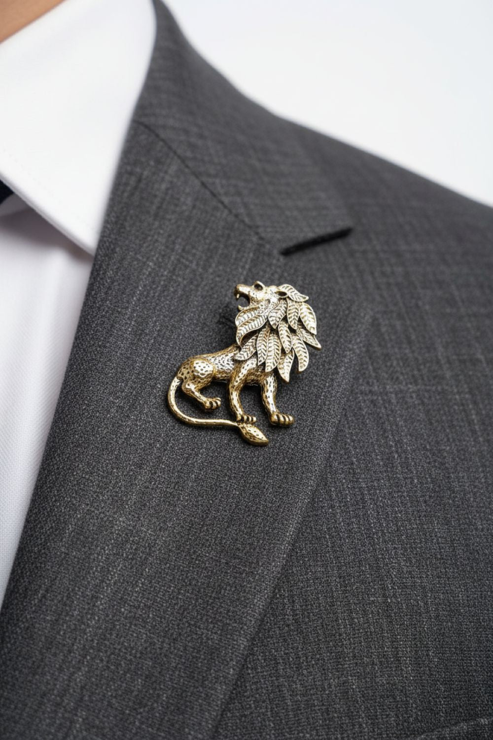 Gold lion brooch on a gray suit jacket