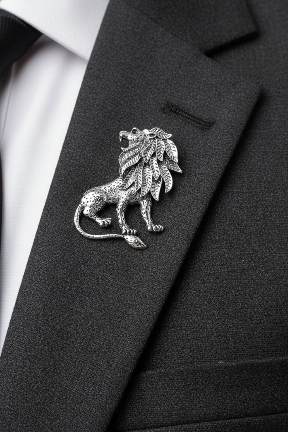 Black suit jacket with a silver lion emblem on a white background