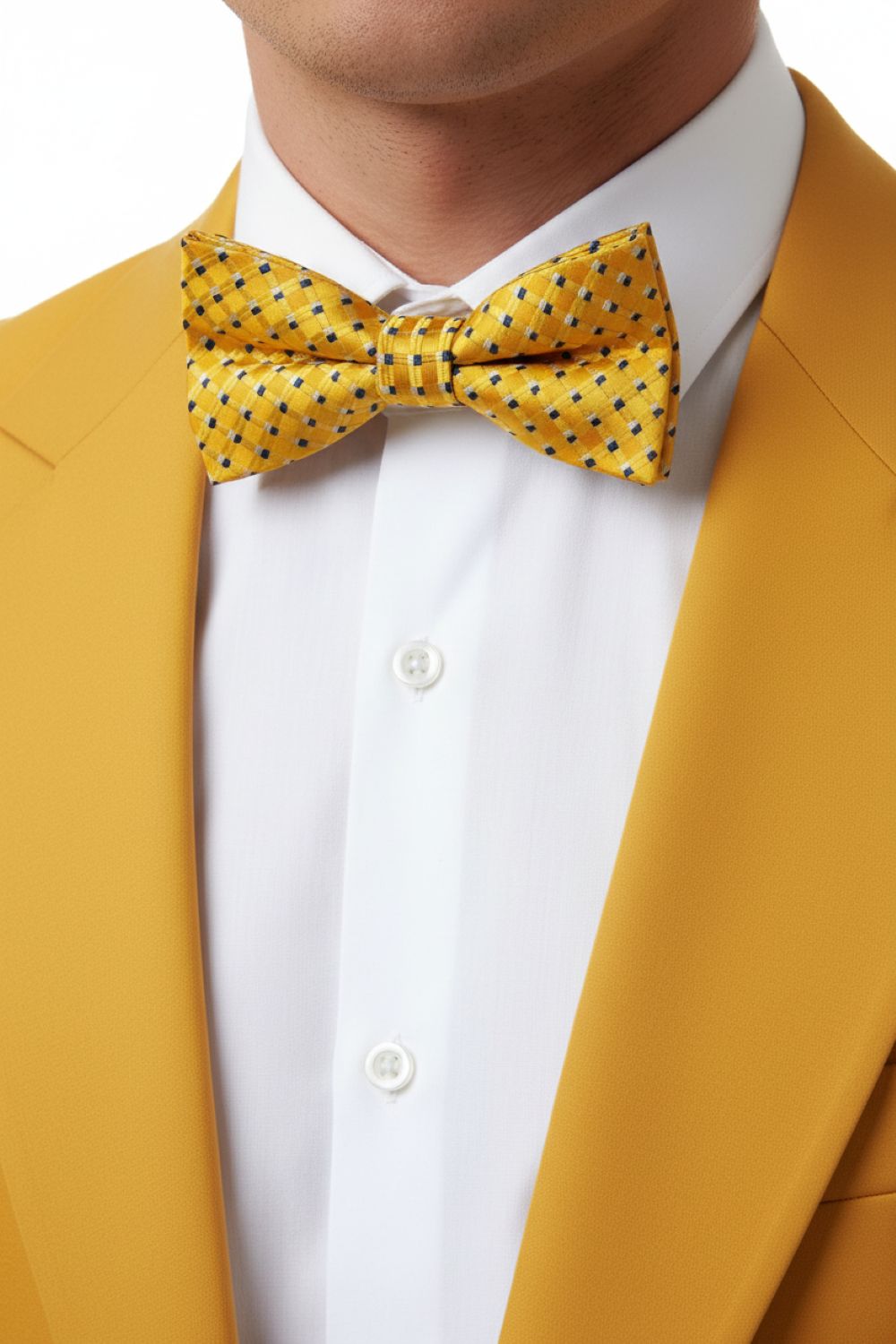 Person wearing a yellow suit with a white shirt and yellow polka dot bow tie.